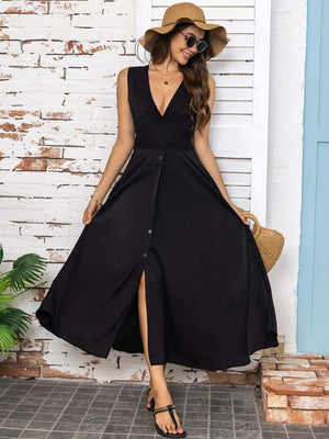 Model wearing a full size slit V-neck sleeveless midi dress in black, styled with a hat and sandals.
