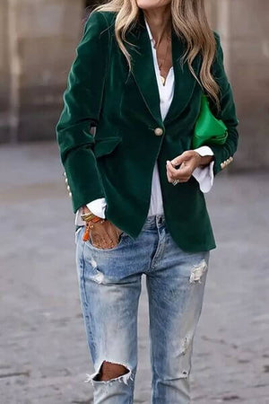 Stylish woman wearing a green lapel collar blazer over a white shirt and ripped jeans, perfect for effortless chic.