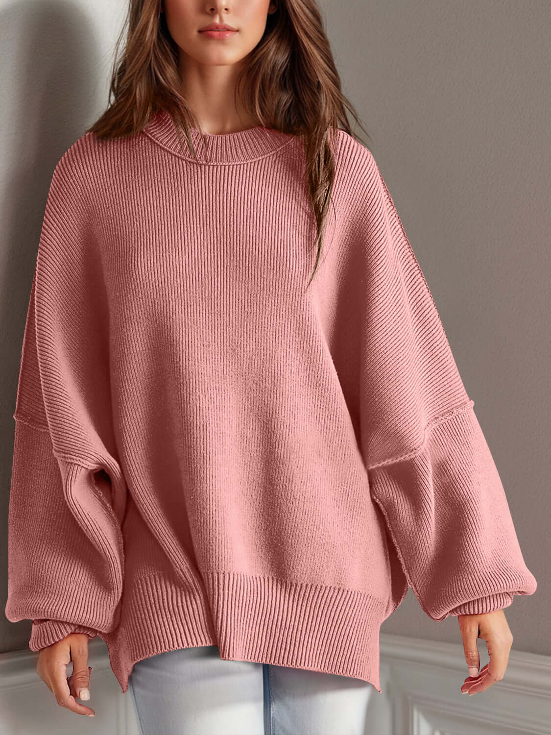 Chic pink side-slit sweater with cozy round neck, featuring moderate stretch and oversized sleeves for ultimate comfort.