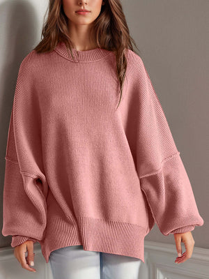 Chic pink side-slit sweater with cozy round neck, featuring moderate stretch and oversized sleeves for ultimate comfort.