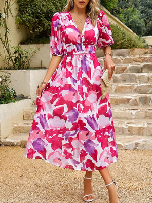 Vibrant printed puff sleeve midi dress featuring colorful floral patterns, perfect for casual outings.