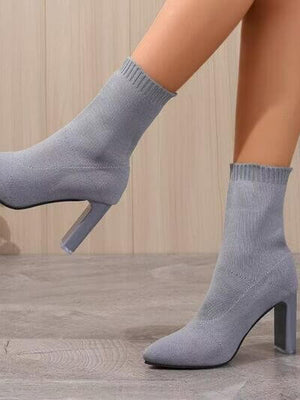 Stylish gray point toe block heel boots with high heels, perfect for fashion-forward outfits.