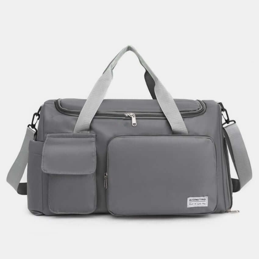 Oversized gray Oxford cloth travel bag with detachable strap and multiple pockets for convenient storage.