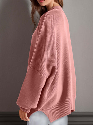 Chic side-slit sweater in soft pink with cozy round neck and relaxed fit, perfect for winter comfort and style.