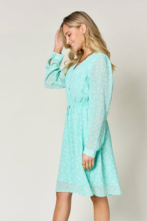 Double Take V-Neck Long Sleeve Ruched Dress in mint green with sheer fabric and stylish print.