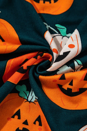 Close-up of pumpkin printed fabric featuring smiling jack-o'-lanterns, ideal for a fun lounge set.