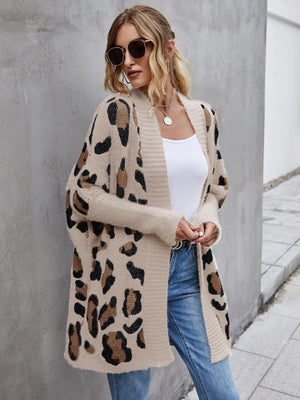 Woman wearing a casual open front angel wings leopard pattern fuzzy cardigan with long sleeves.