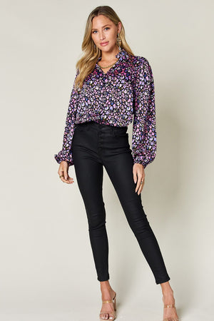 Model wearing Double Take Full Size Printed Long Sleeve Blouse in vibrant floral print paired with black skinny jeans.