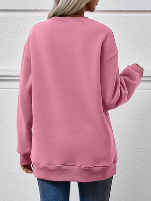Back view of a pink round neck sweatshirt, showcasing a relaxed fit and cozy design.