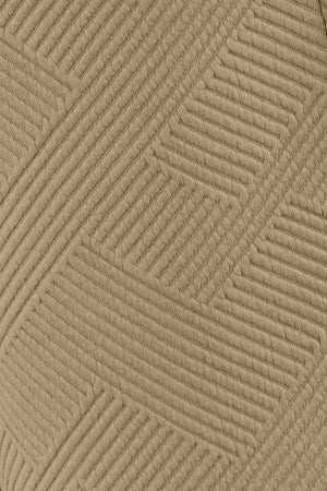 Close-up of textured beige fabric with a subtle geometric pattern.