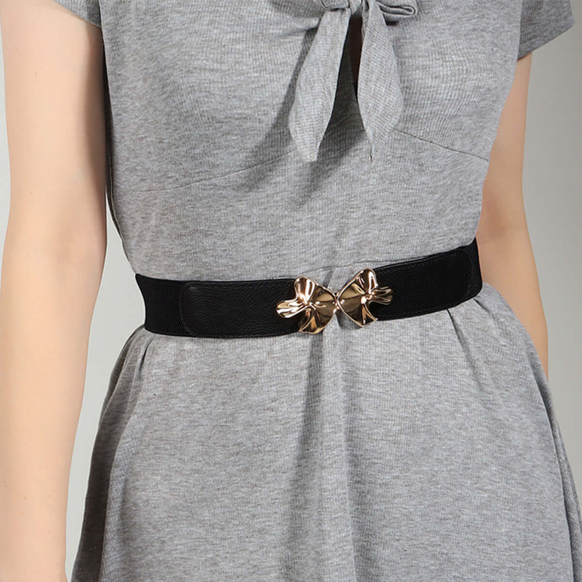 Stylish Alloy Buckle Elastic Belt on a grey dress, featuring a chic dual bow design, perfect for accessorizing outfits.
