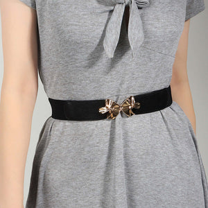 Stylish Alloy Buckle Elastic Belt on a grey dress, featuring a chic dual bow design, perfect for accessorizing outfits.