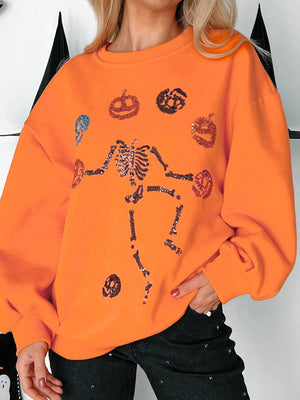 Halloween skeleton pumpkin sweatshirt in orange with sequin details, perfect for festive celebrations.