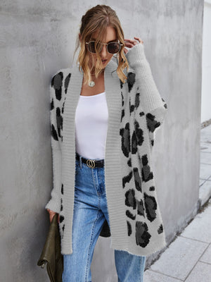 Casual leopard pattern fuzzy cardigan with open front, long sleeves, styled with jeans and sunglasses.