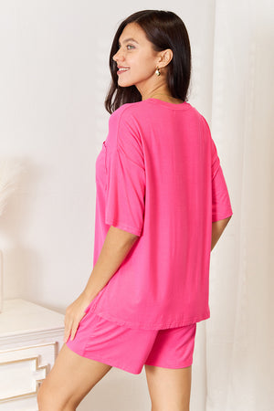 Model wearing a vibrant pink half sleeve top and shorts set, showcasing a relaxed and stylish loungewear look.