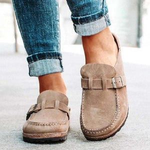Round toe low heel buckle loafers in beige, paired with rolled-up jeans, perfect for casual styling.