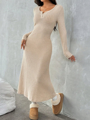 Model wearing a ribbed long sleeve knit dress in beige, paired with cozy slippers, showcasing a stylish yet comfortable look.