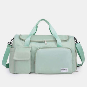 Oxford cloth travel bag with detachable strap, oversized design in mint green, perfect for travel or gym use.