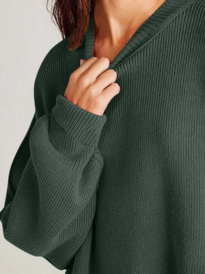 Close-up of a cozy green sweater featuring a ribbed texture and round neck for ultimate comfort and style.