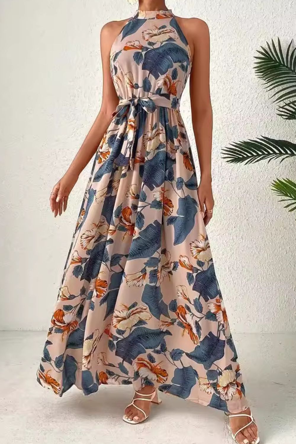 Elegant tied slit floral sleeveless dress with vibrant patterns, ideal for summer occasions and stylish events.