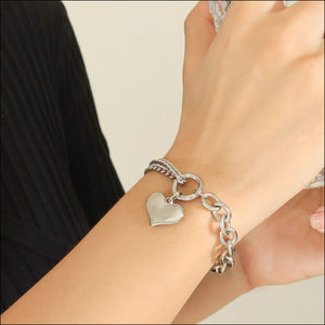 Half chunky chain titanium steel bracelet displayed on a wrist, featuring a heart charm, stylish and durable for everyday wear.