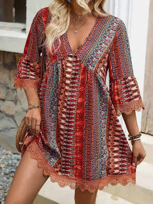 Lace trim printed V-neck dress with 3/4 sleeves, featuring vibrant patterns and casual style.