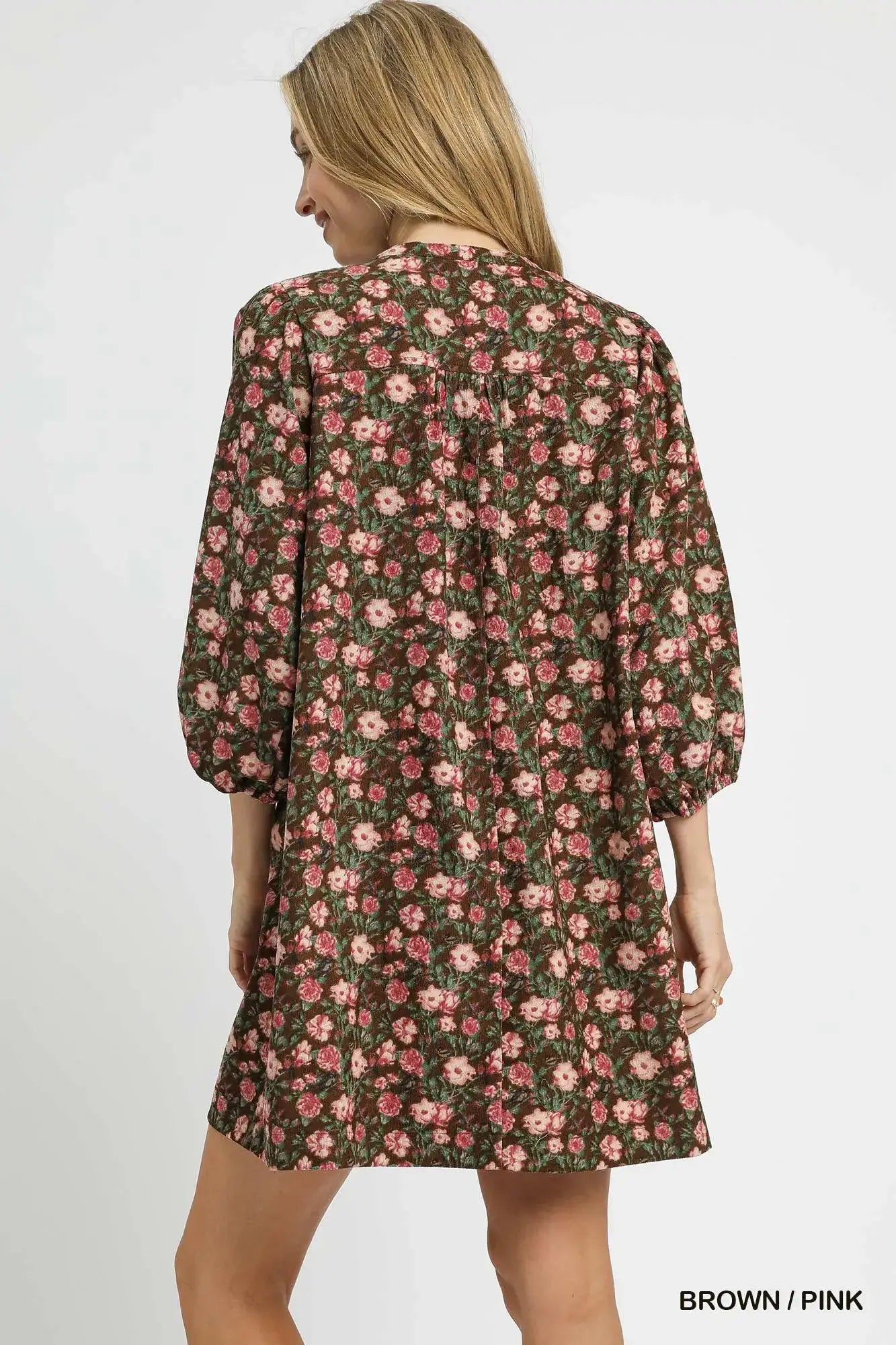 Back view of the Umgee Floral Tie-Neck Babydoll Dress in brown and pink, showcasing its charming floral print and puff sleeves.