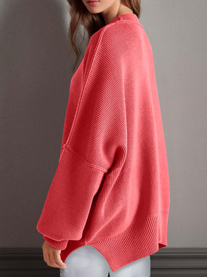 Chic side-slit sweater in coral with a cozy round neck, perfect for winter layering and comfort.