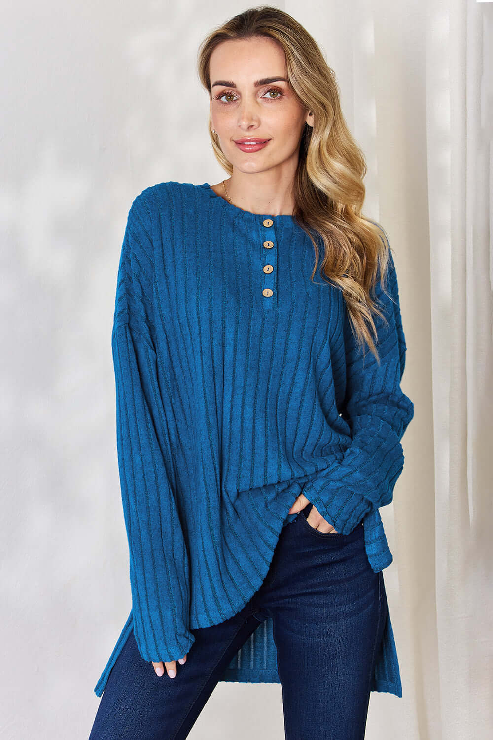 Model wearing Basic Bae ribbed high-low T-shirt in teal with button detail and long sleeves.