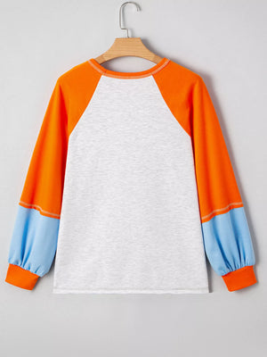 Back view of a Halloween Pumpkin Print Long Sleeve T-Shirt with orange and blue raglan sleeves.