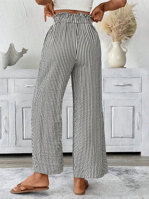Back view of plus size striped wide leg paper bag pants, featuring a tied waistband and pockets.