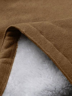 Close-up of soft brown fabric with plush white lining, showcasing texture and quality for cozy apparel.