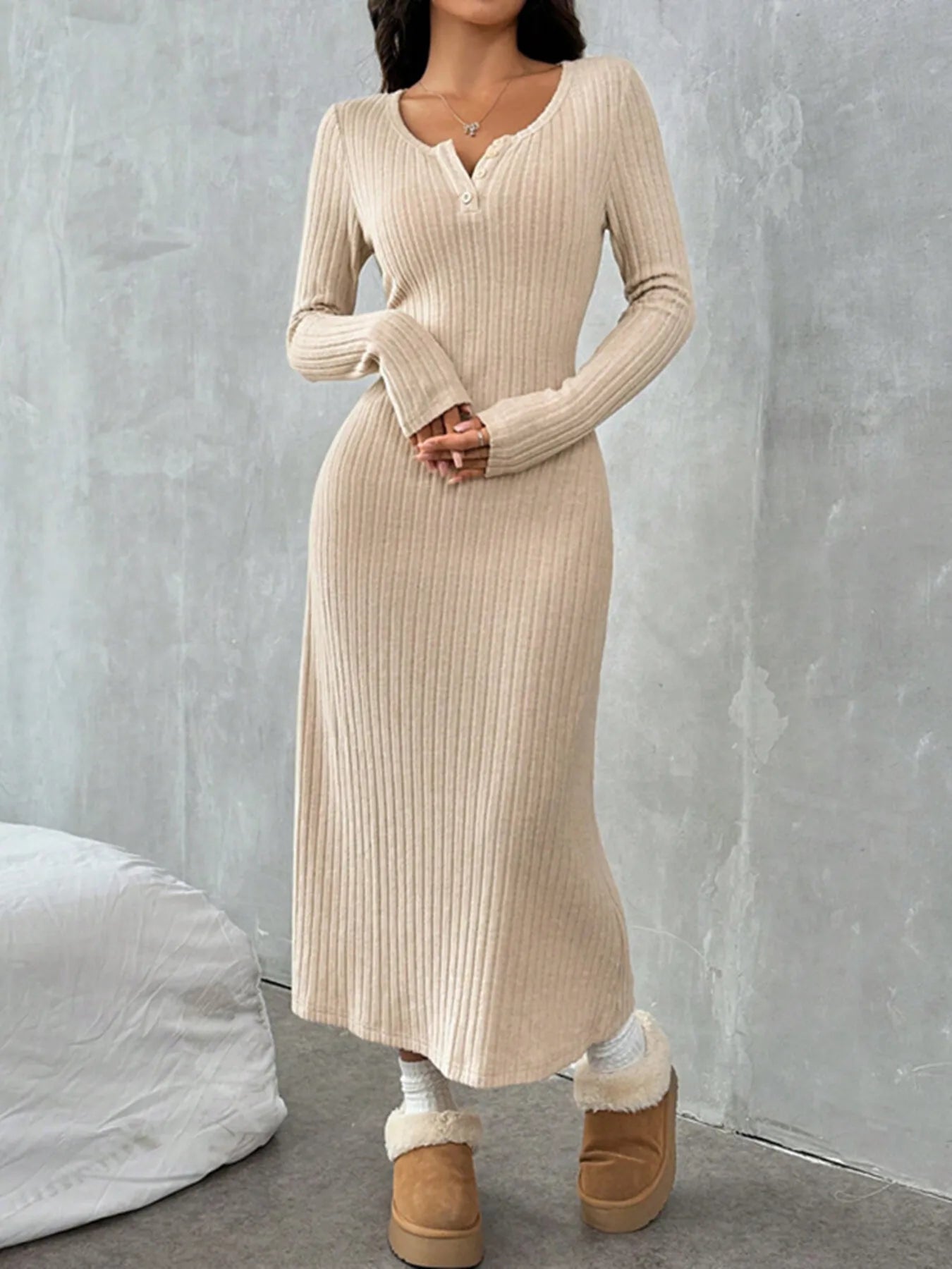 Ribbed long sleeve knit dress in beige, featuring buttoned detail and slight stretch for comfort.