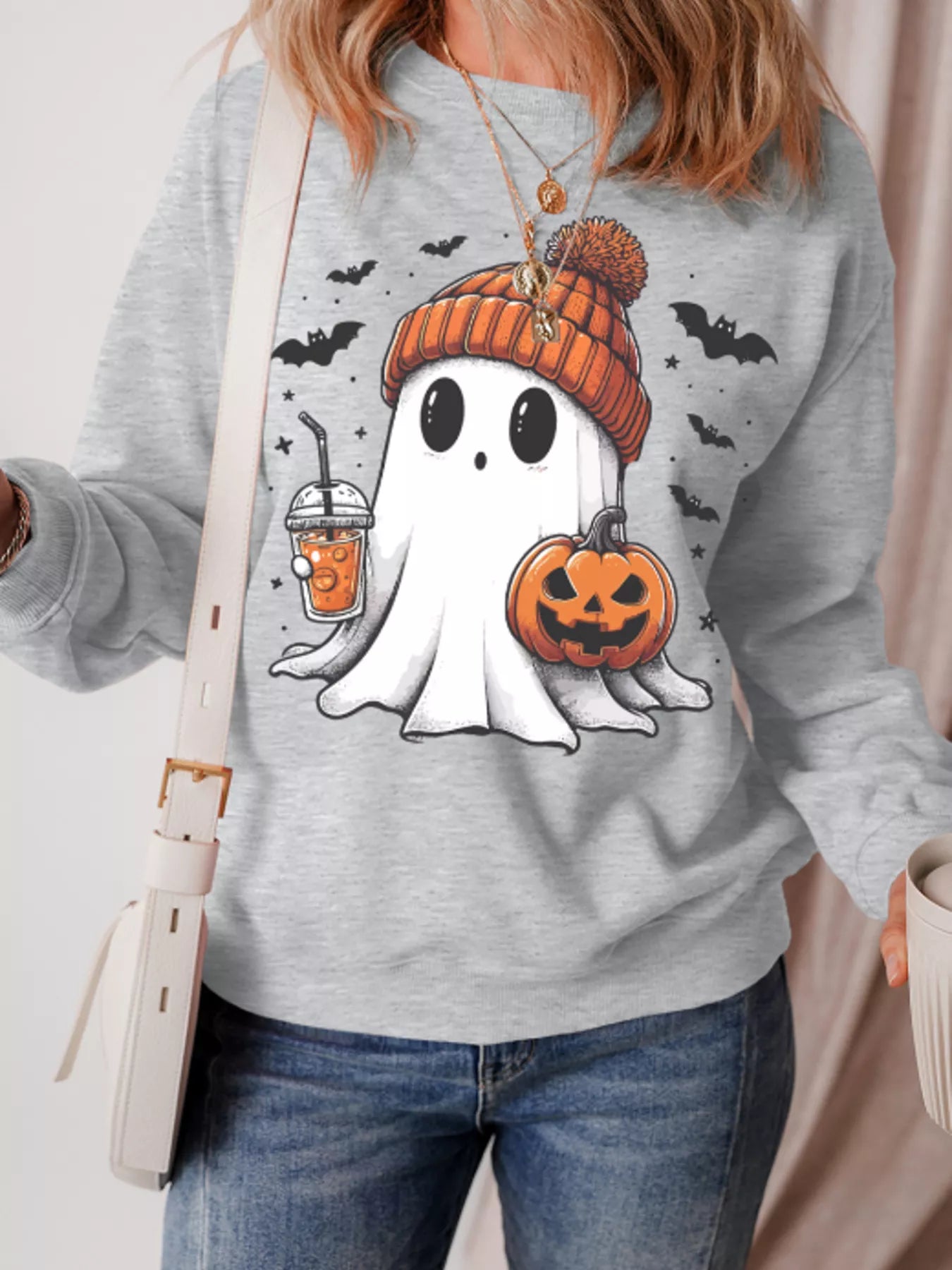 Halloween ghost sweatshirt with pumpkin and drink, perfect for festive fall fashion.