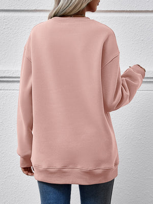 Back view of a pink round neck sweatshirt, showcasing its relaxed fit and cozy design.