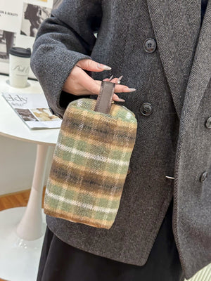 Stylish Contrast Plaid Clutch with Zipper held by a person, featuring cozy plaid design in green and brown tones.