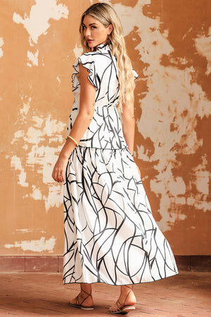 Model wearing a Ruffled Printed Surplice Cap Sleeve Dress, showcasing a black and white design from the back.