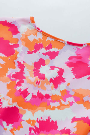 Colorful floral printed fabric featuring pink and orange hues for a stylish blouse.