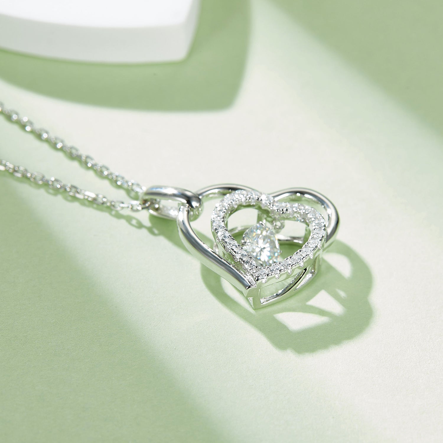 Moissanite 925 sterling silver heart necklace featuring a sparkling center stone and delicate chain.