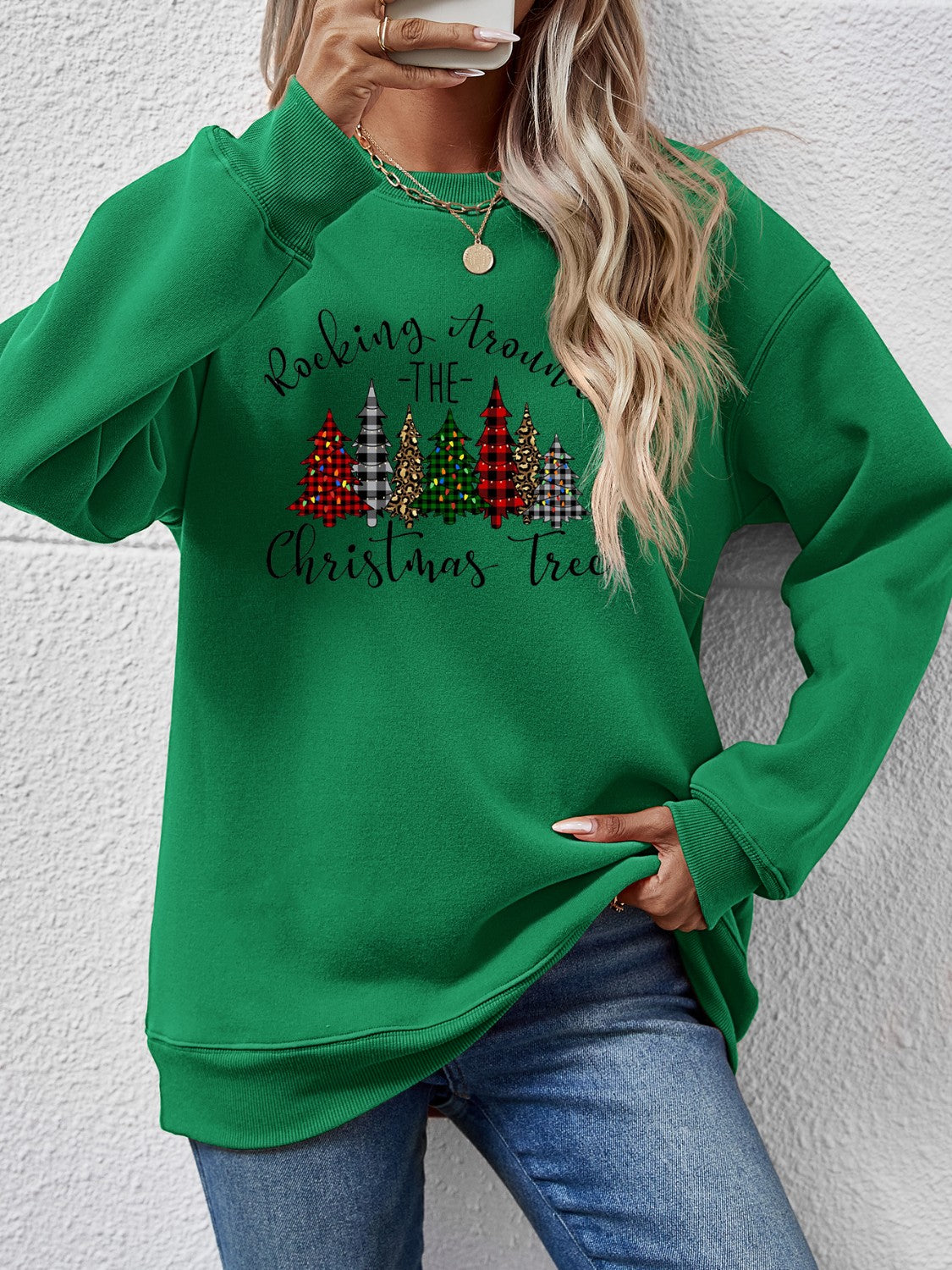Green sweatshirt with Christmas tree graphic, perfect for festive occasions and cozy winter wear.