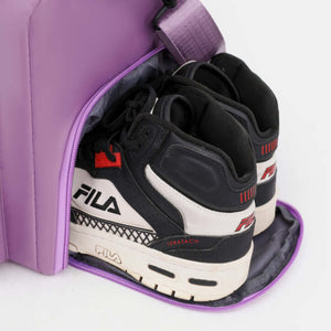 Purple travel bag with detachable strap showing Fila shoes inside, perfect for stylish travel and organization.