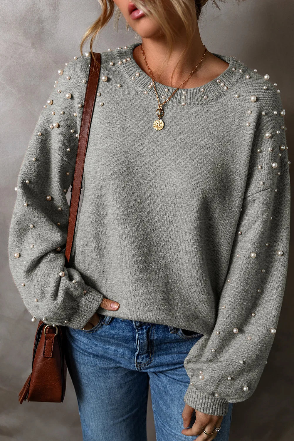 Stylish gray long sleeve sweater with pearl details, perfect for casual outfits.