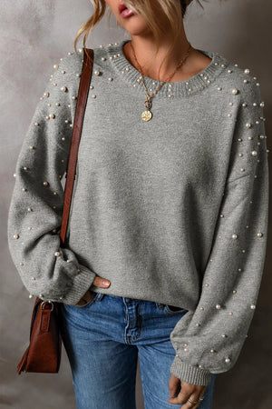 Stylish gray long sleeve sweater with pearl details, perfect for casual outfits.