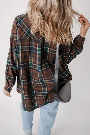 Stylish woman wearing a plaid button-up long sleeve jacket with a shoulder bag.