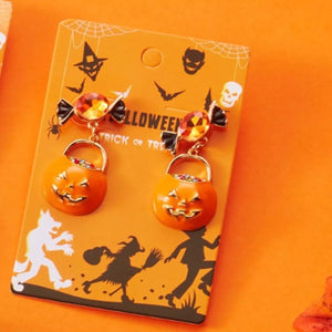 Halloween pumpkin drop earrings with orange rhinestones on festive packaging. Perfect for spooky holiday style!