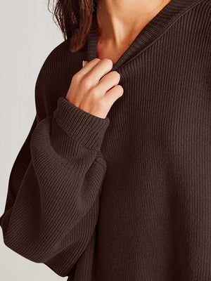 Model wearing a cozy brown side-slit sweater, highlighting its soft material and round neck design.