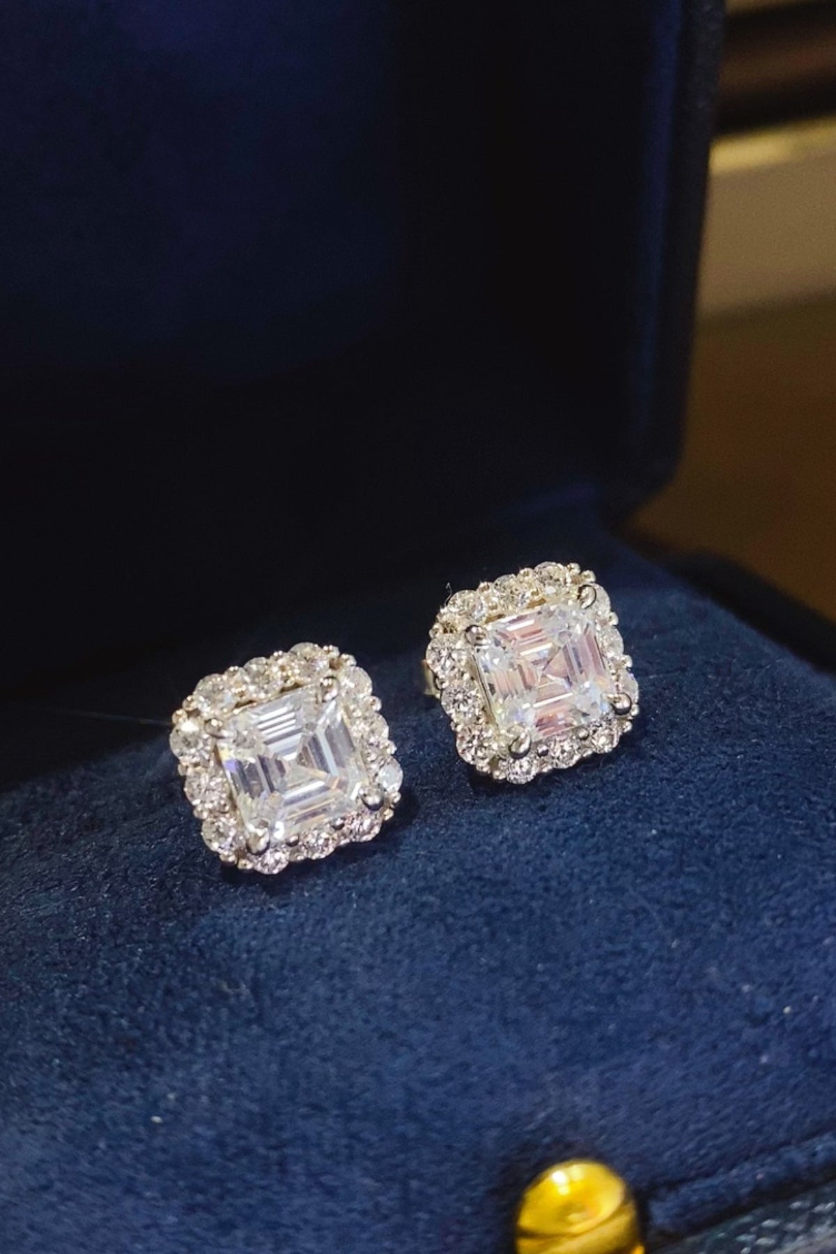 2 carat moissanite 925 sterling silver stud earrings in a matching box, showcasing stunning sparkle and elegant design.