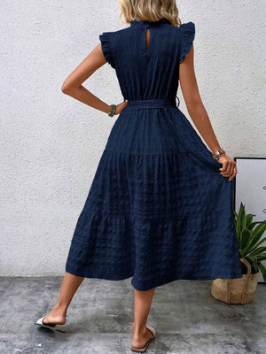 Back view of a Tied Ruffled Cap Sleeve Midi Dress in navy, showcasing a flowing silhouette and stylish design.