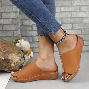 Stylish PU leather open toe sandals with low heels, perfect for summer, shown with casual jeans in a natural setting.