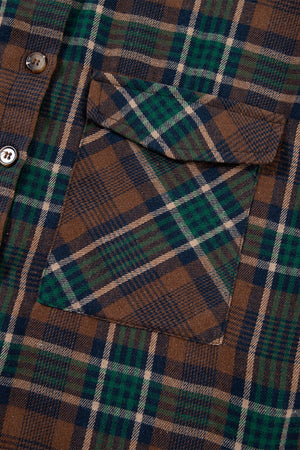 Close-up of a plaid button-up jacket showing a chest pocket, featuring brown, green, and navy check patterns.